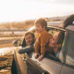 Photo of cute little family during their excursion with family car